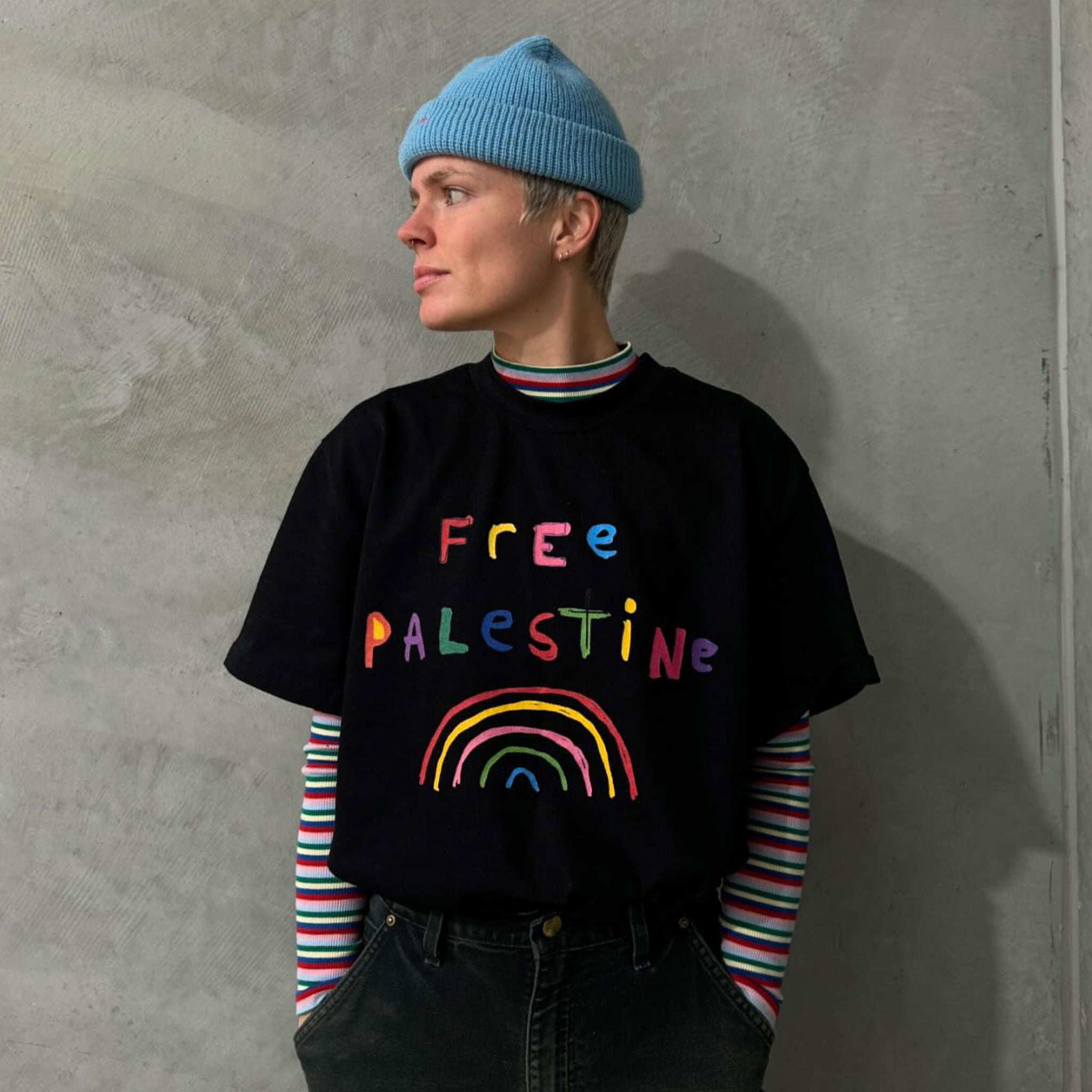 Artist / Illustrator, Shuturp, wearing the Free Palestine Oversized Black Charity T-shirt she designed.