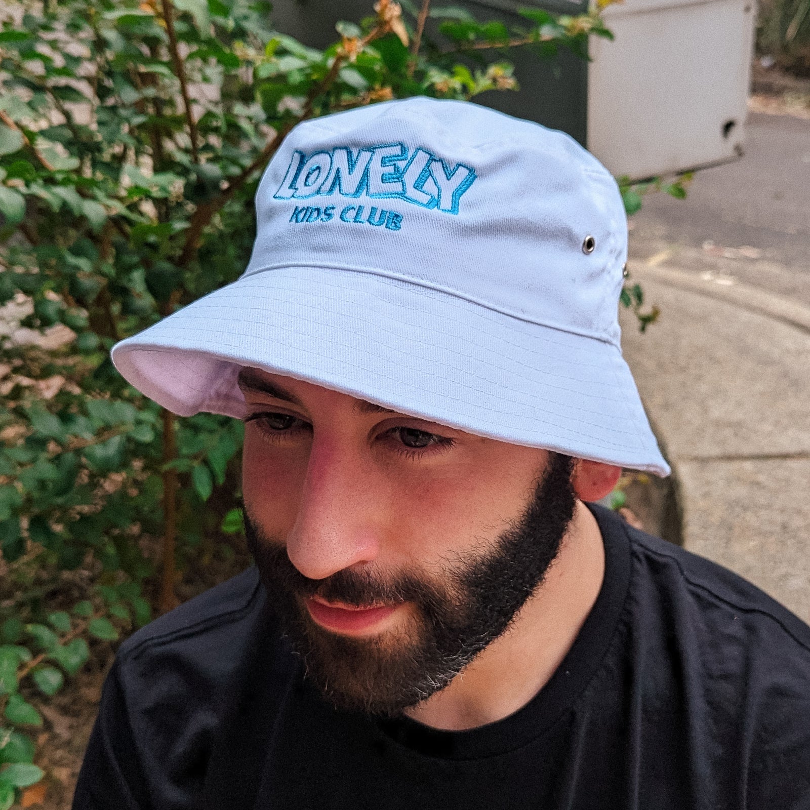 White bucket hat with LKC Logo Bucket Hat graphic by Lonely Kids Club