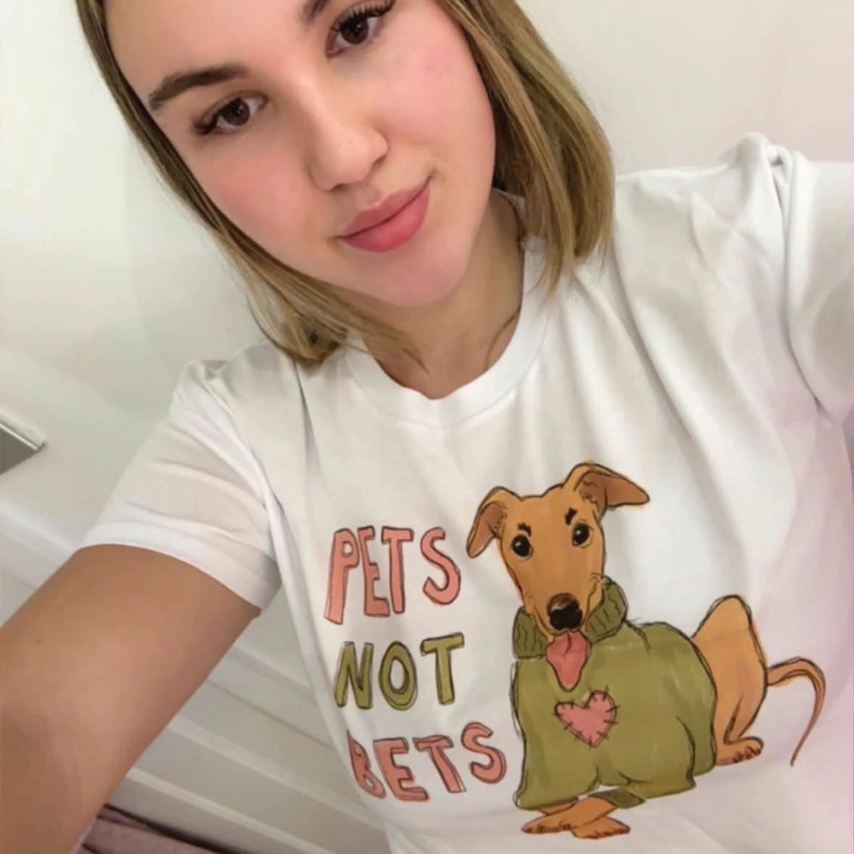 White unisex t-shirt with Pets Not Bets graphic by Lonely Kids Club