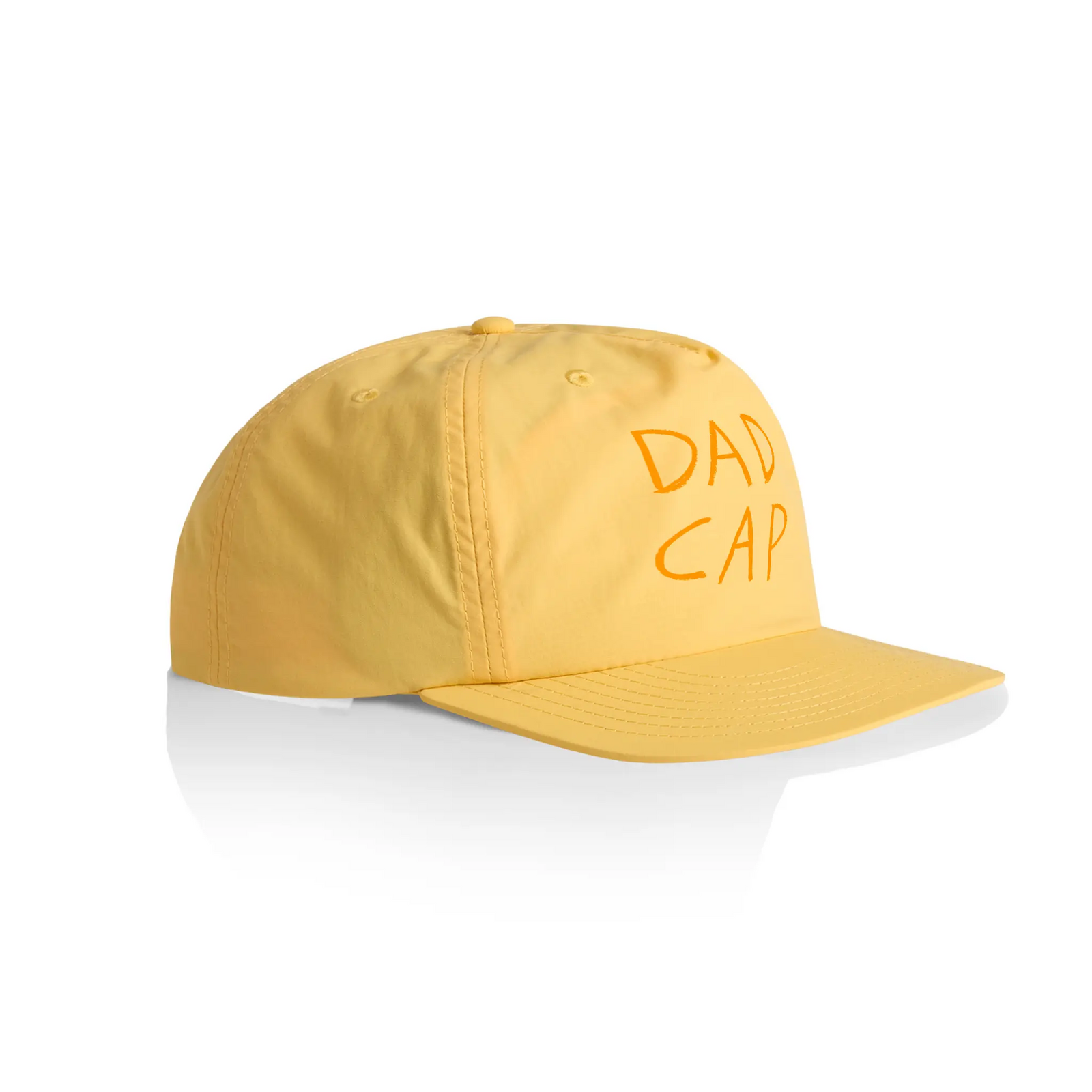 Product photo of dad cap in side profile in orange colour. Shown against a white background.