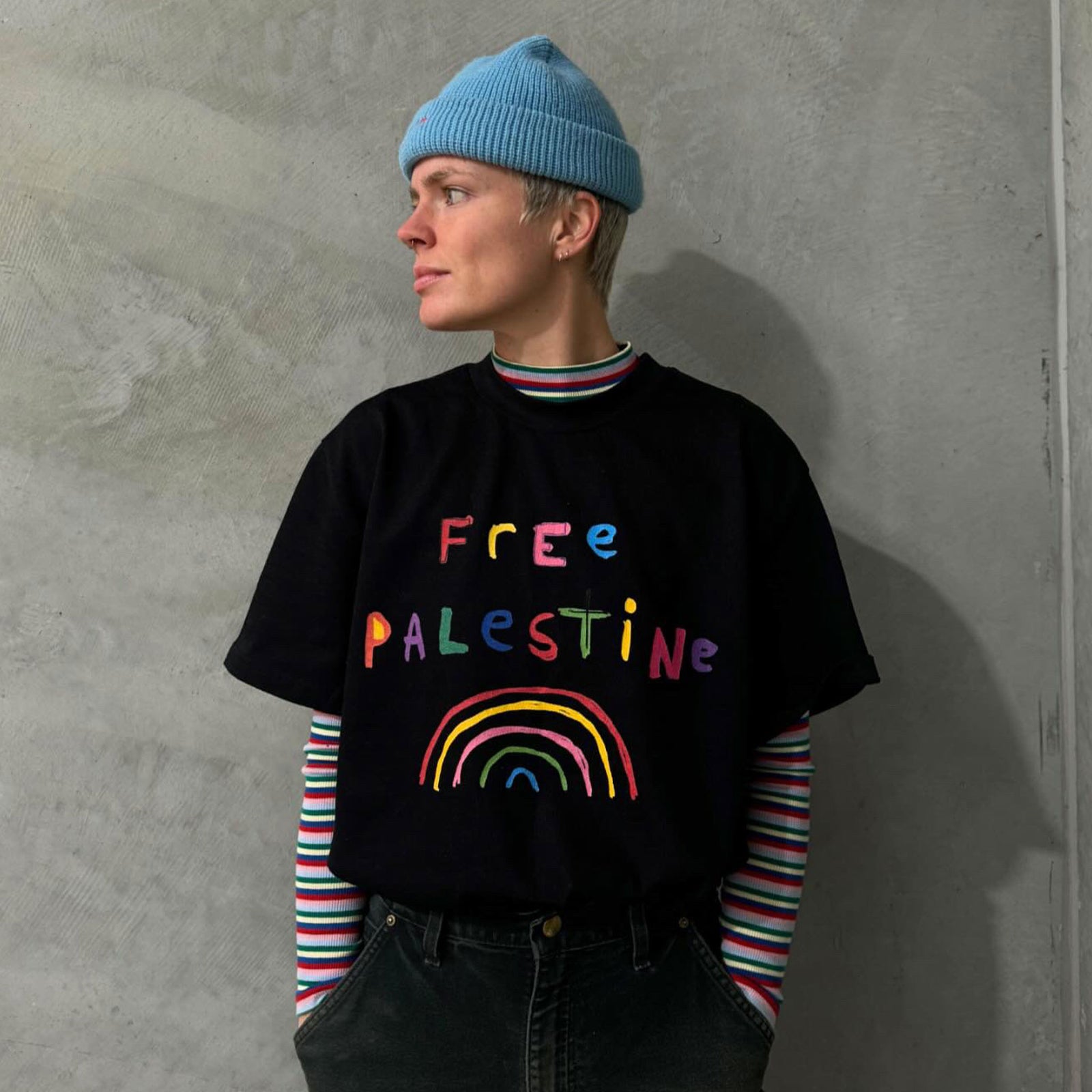 Artist / Illustrator, Shuturp, wearing the Free Palestine Oversized Black Charity T-shirt she designed.